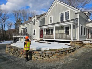 worker surveying house